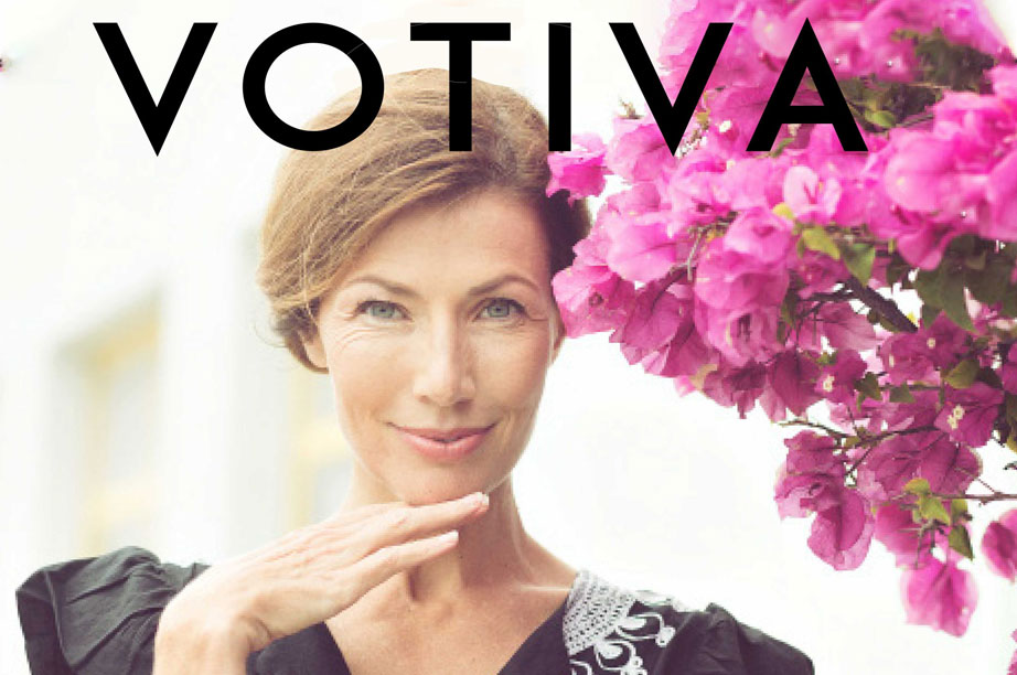 woman with hand under chin next to flowers under word Votiva